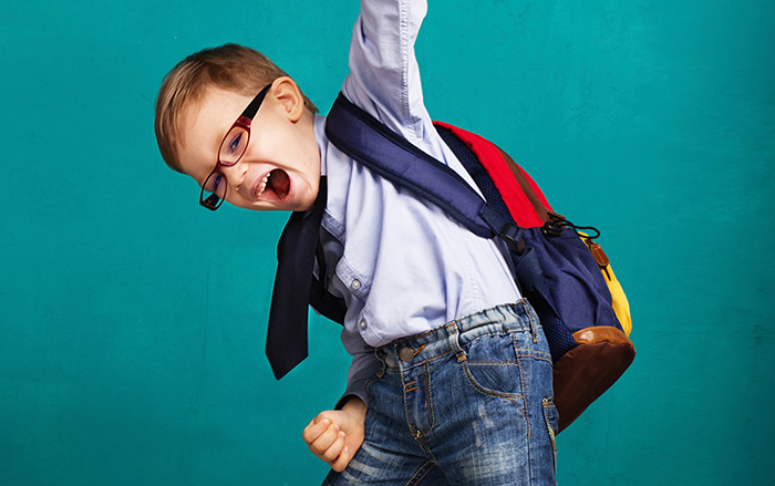 Boy with rectangular eyeglasses very happy to go to school