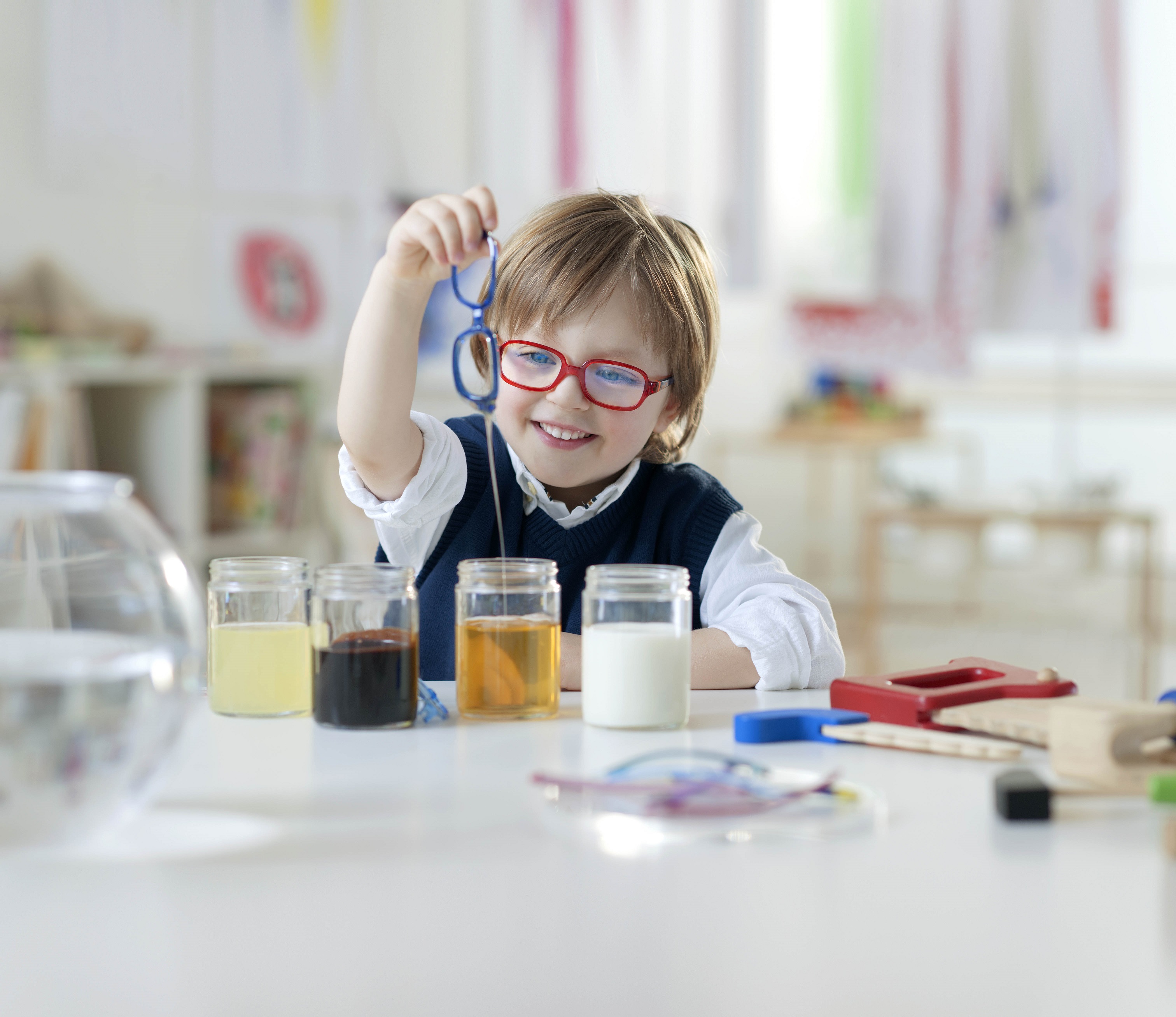 A kid submerging his frames on a liquid to show how resistant they are