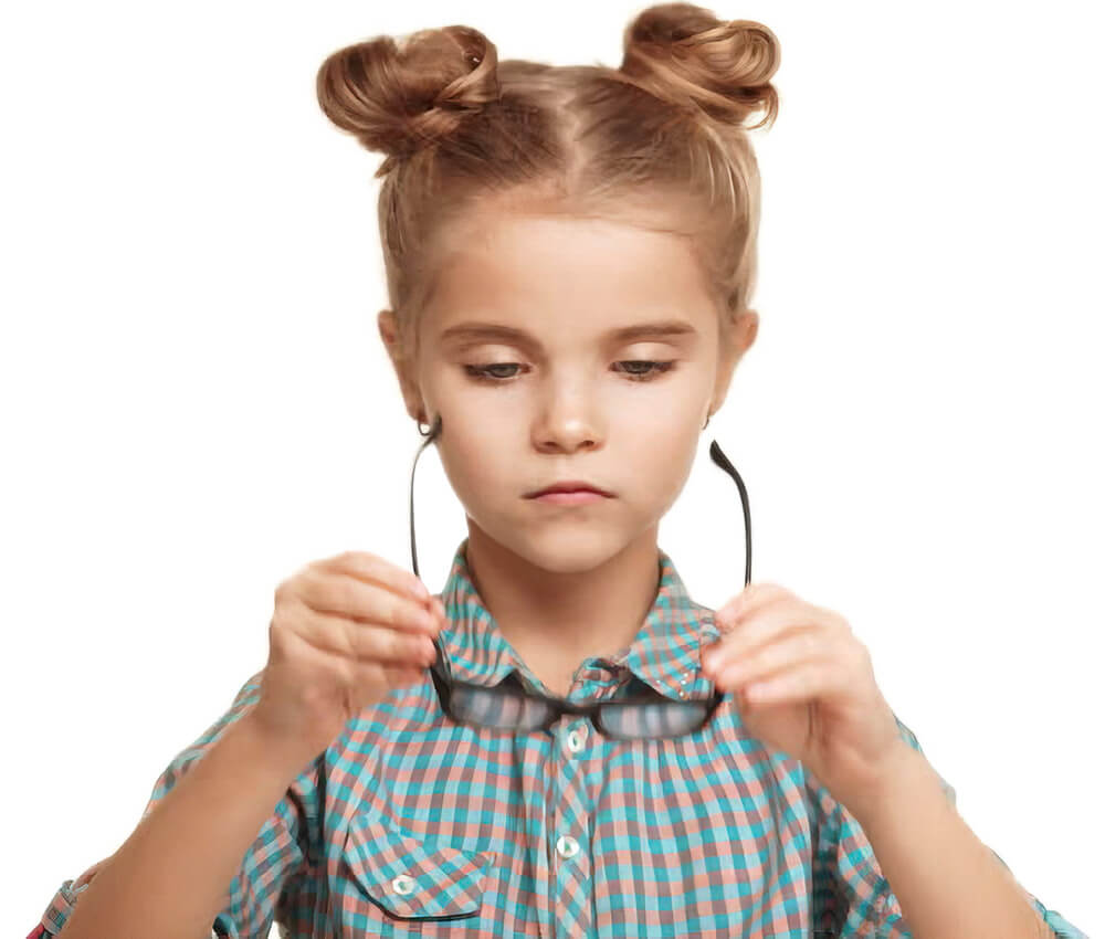 Young girl holding her eyeglasses and trying to focus because she can't see well without them